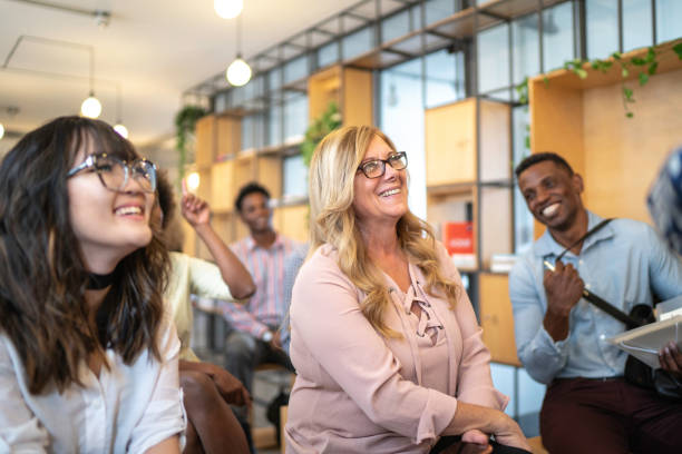 Audience laughing at business convention and presentation