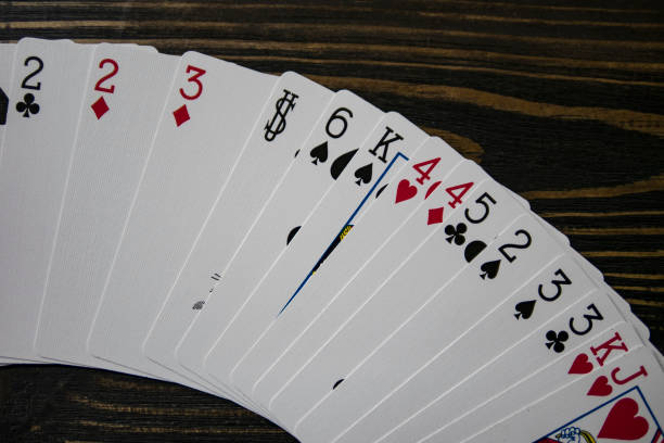 istock playing cards on the table, beautiful wooden background, copy space 1147344459