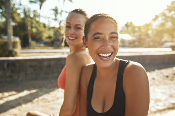 istock Laughing young women taking a break from an outdoor workout 1147346021