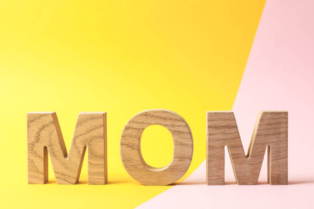 istock Inscription mom on two tone background, space for text 1147346124
