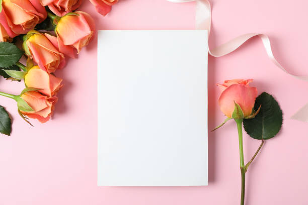 istock Composition with pink roses, ribbon and space for text on color background, top view 1147346183