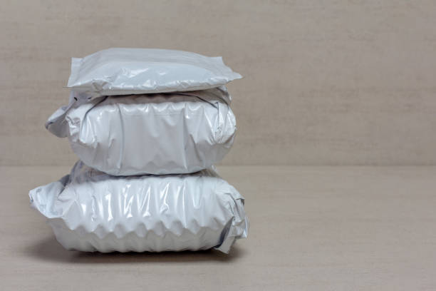 istock a bunch of grey post packages from Chinese stores close up on a grey background with copy space 1147347069