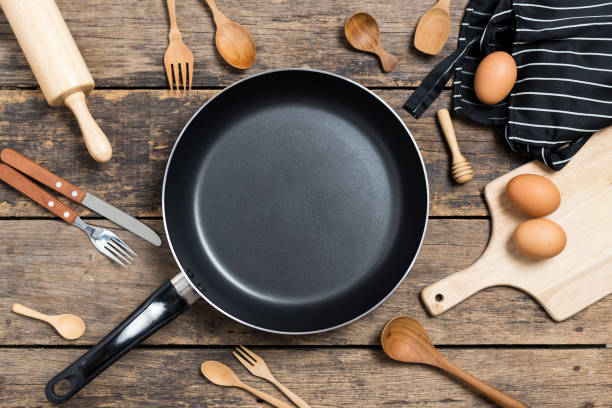 istock Cooking background,Top View of a Pan and different kitchenware On Old Wood Background 1147347692