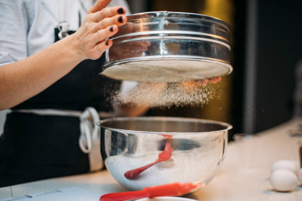istock Woman hands sieving flour 1147348160