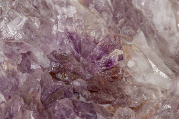 istock Macro of amethyst mineral stone on black background 1147348508