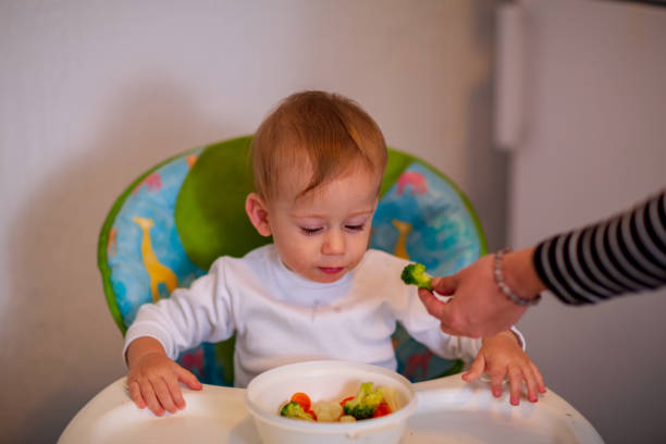 istock smiling messy baby likes to eat 1147348782