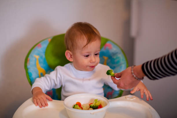 istock smiling messy baby likes to eat 1147348876
