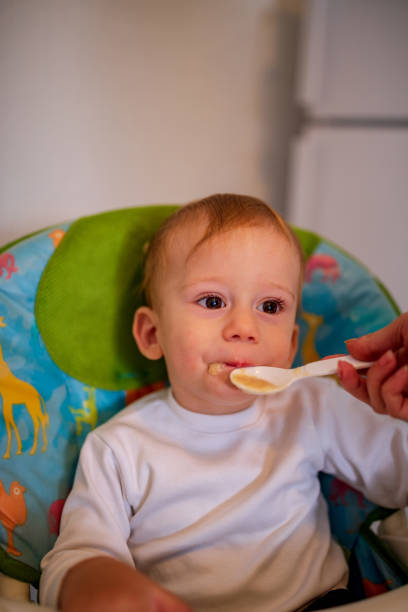 istock smiling messy baby likes to eat 1147349004