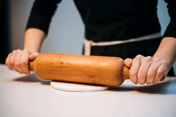 istock Close up of female baker hands kneading dough 1147349059
