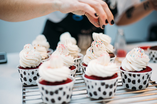 Woman hand decorating cupcakes