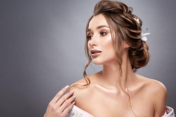 istock pretty brunette looking sideways and touching her shoulder 1147350395