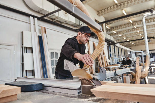 istock A lasting value. Focused carpenter at work with wooden plank 1147351632