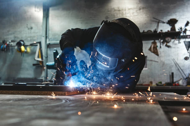 istock Weld Done Well. Man welds at the factory 1147351812