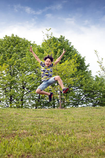 istock Agile young boy leaping high in the air 1147355490