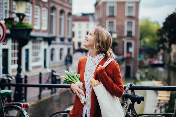 istock Dutch woman with tulips 1147358764