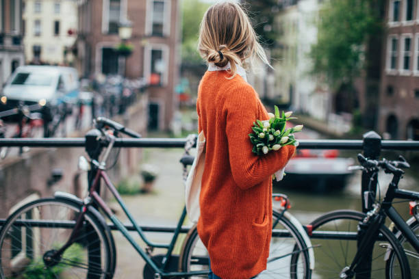 istock Dutch woman with tulips 1147358783
