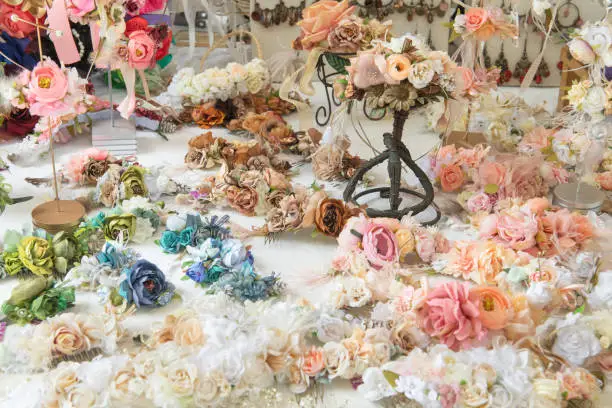 Various colorful artificial flowers, handmade by artisan and exposed in medieval market