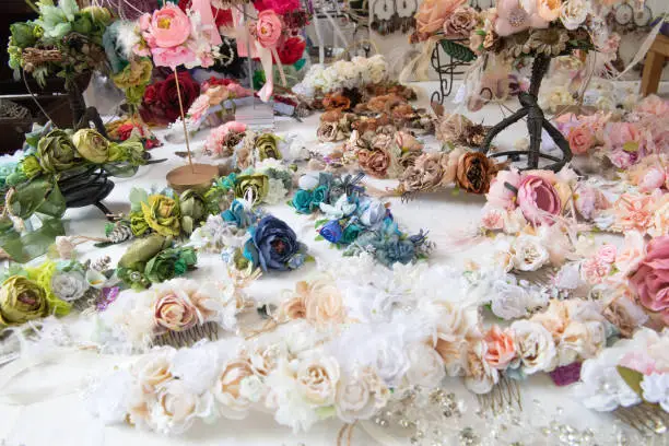 Various colorful artificial flowers, handmade by artisan and exposed in medieval market