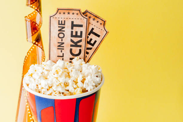 istock Movie tickets, film strips and popcorn on blue background. Copy space for text 1147362482