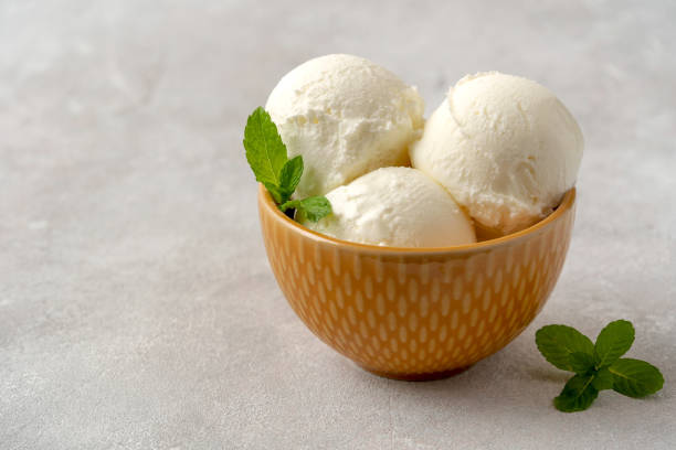 istock Tasty vanilla ice cream  in bowl on table 1147363348