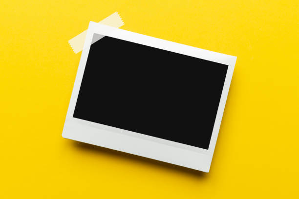 Blank photo paper on yellow background.