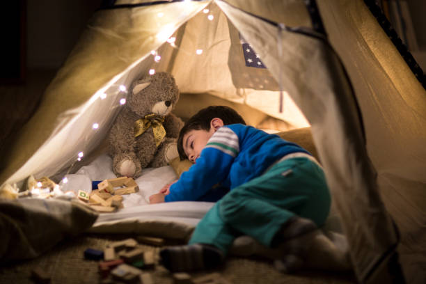 istock Sleepy boy taking a nap inside of a tent at home 1147363713