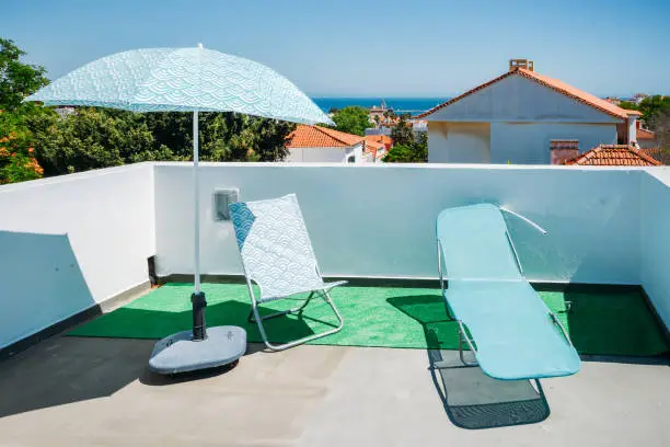 Photo of Sun beds and umbrellas on terrace in a luxury summer resort with Atlantic sea view in Cascais, Portugal