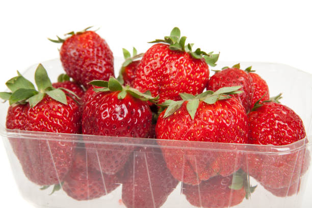 istock Fresh strawberries in plastic box, isolated on white 1147363794