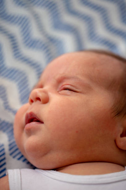 istock Cute little baby boy, relaxing in bed 1147364739