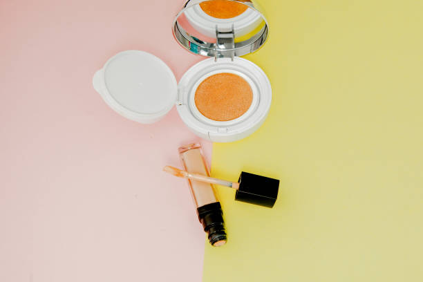 istock Make up products spilling on to a bright yellow and pink background with copy space 1147364899