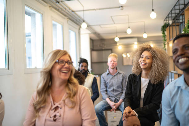 istock Audience laughing at business convention and presentation 1147366120