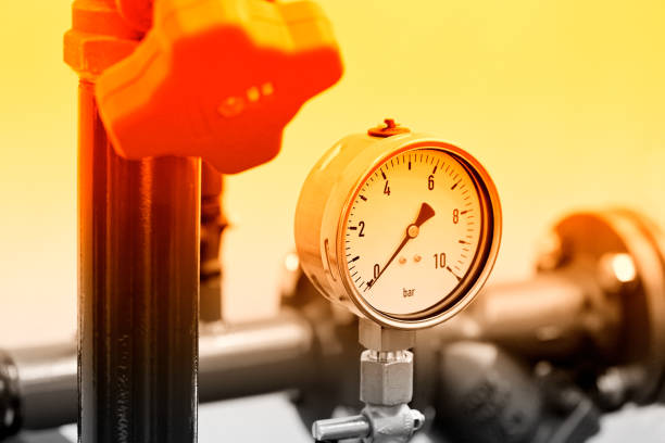 Hydraulic pressure gauge, manometer - instrument for measuring the pressure of fluid on a hydraulic equipment. Red toned