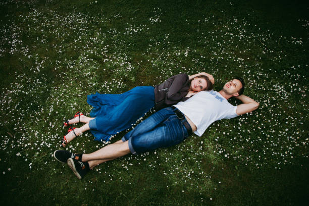 istock Couple lying and relaxing on the grass. Top view. 1147366625