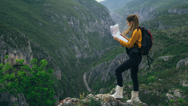 istock Female hiker checks map 1147369345