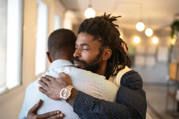 Photo of Businessman embracing celebrating good news