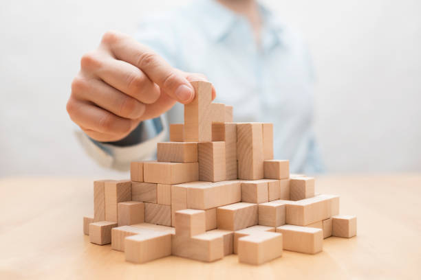 istock Man's hand stacking wooden blocks. Business development concept 1147372478