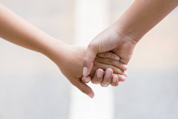 istock Parent and Child Holding Hands 1147372904