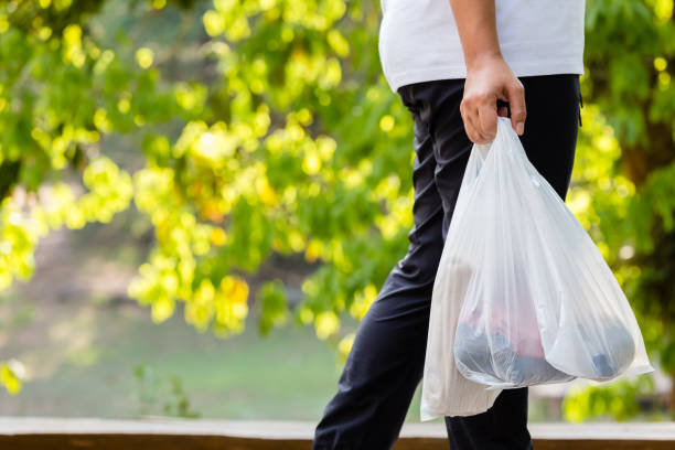 Woman Carry Plastic Bags Closeup woman carry the grocery plastic bags while walking in the forest park, environment concept plastic bag stock pictures, royalty-free photos & images