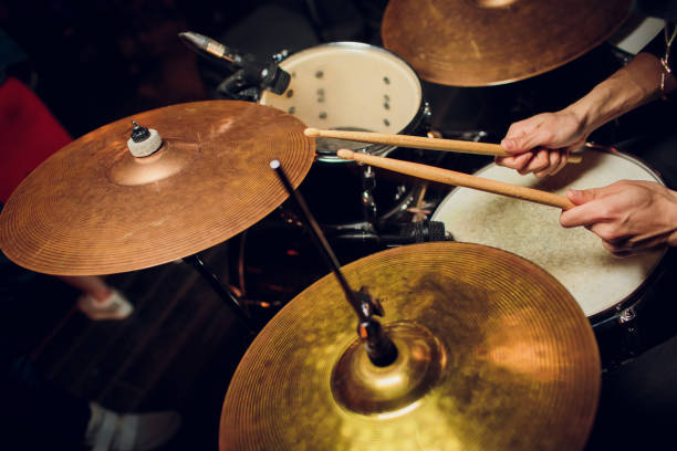 istock Vintage toned live music background, drummer plays with drumsticks on rock drum set 1147373962