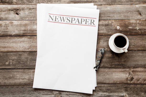 Newspaper and coffee on wooden background stock photo