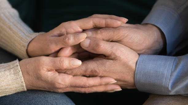 istock Close up aged wife holding husband hands, showing support, love 1147376399