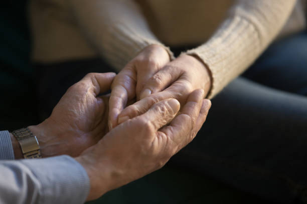 istock Close up aged couple holding hands, showing support and love 1147376412