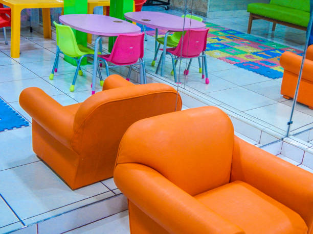 istock Chairs and tables for children reflected in a mirror in a kindergarten 1147377080