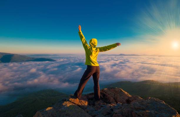 istock A woman on top mountain, summer cloudscape 1147377946