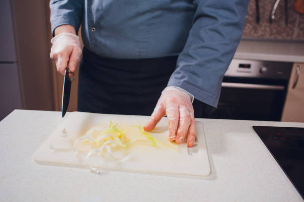 istock hand holding knife cut green cabbage which on white plastic cutting board for prepare cook in kitchen 1147380068