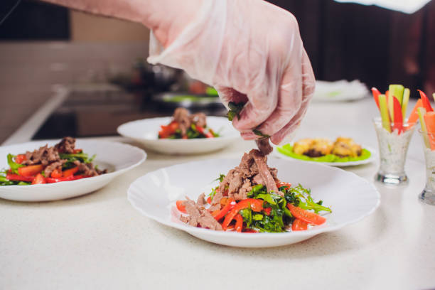 istock Chief cook preparing fresh salad with sauce in glass 1147381426
