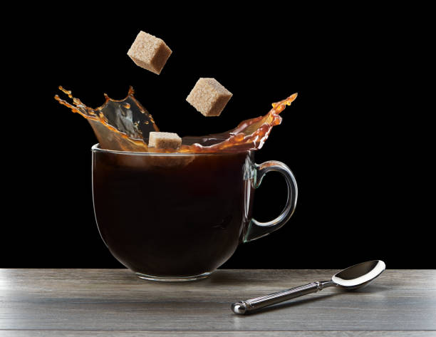 istock Cubes of sugar falling in coffee 1147384458