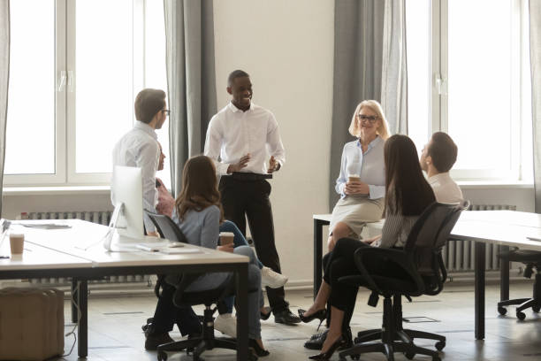 istock Black team leader boss talking with corporate staff at break 1147384803