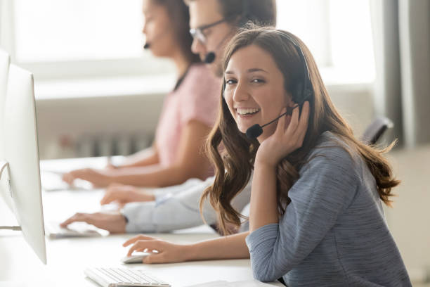 istock Call center employee female sitting at workplace pose for camera 1147384839