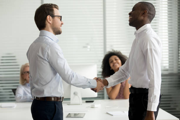 istock Happy diverse businessmen greeting each other with handshake 1147384841